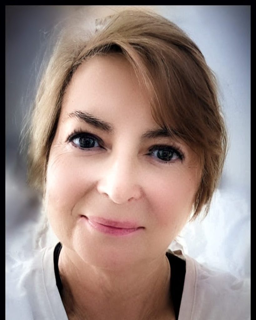 Portrait of Renee, smiling warmly with a soft, inviting expression.
